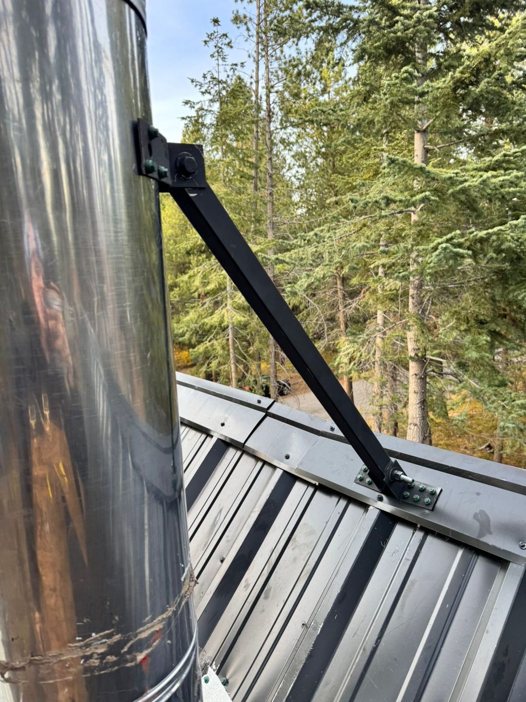 Heavy-duty black spur brace anchored to a metal roof