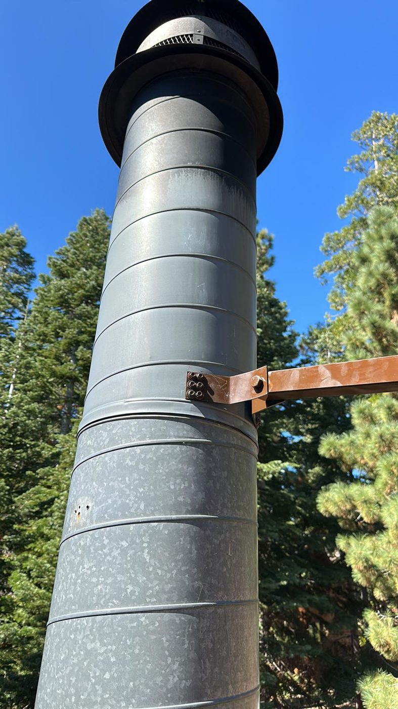 Brown painted chimney brace matched to the roof